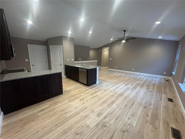 kitchen featuring a ceiling fan, light wood-style flooring, a peninsula, light stone countertops, and vaulted ceiling