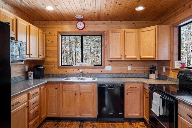 kitchen featuring wooden ceiling, recessed lighting, wooden walls, a sink, and black appliances