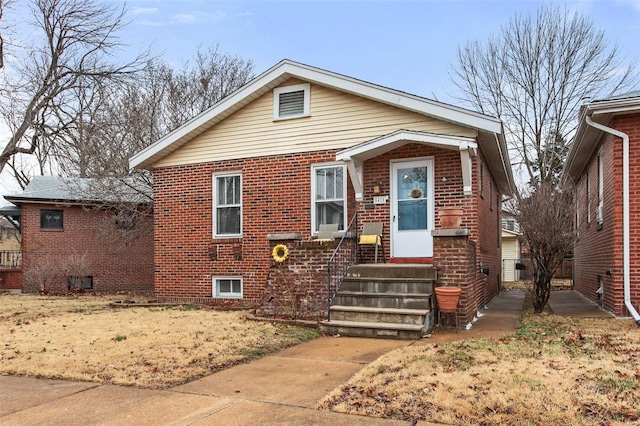 bungalow-style house featuring brick siding