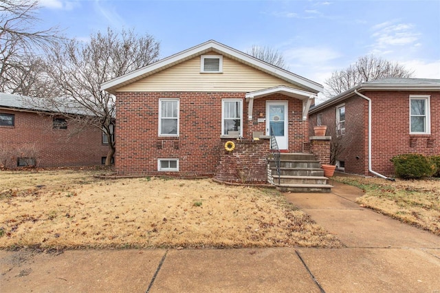 bungalow-style house with brick siding