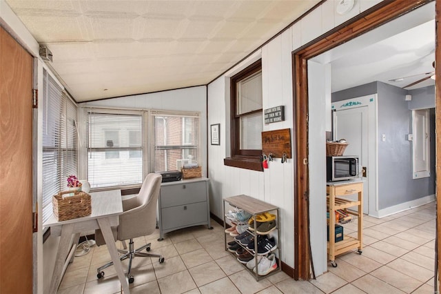 office with light tile patterned floors, baseboards, lofted ceiling, and wooden walls