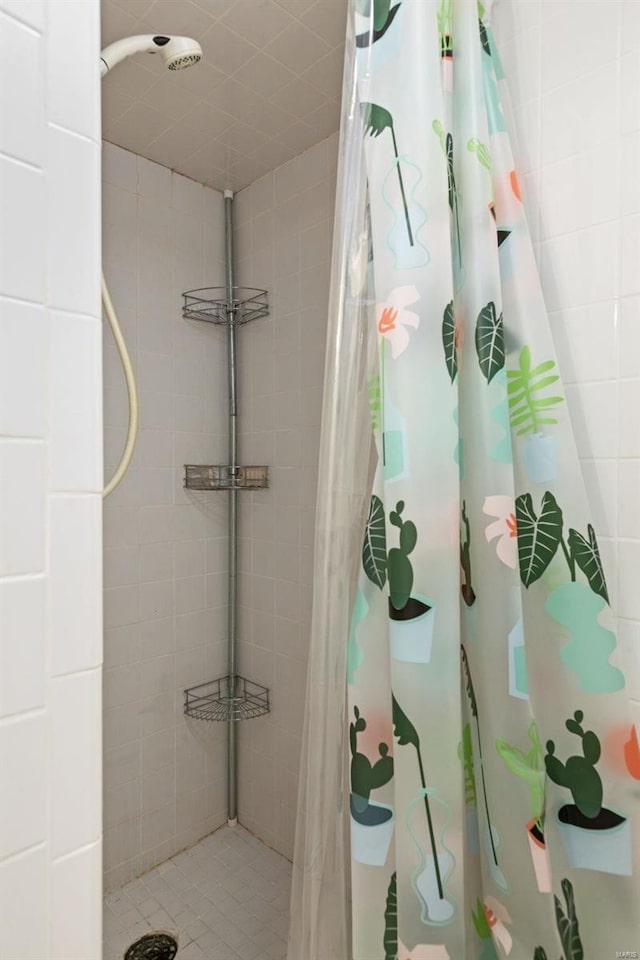 full bath with a tile shower