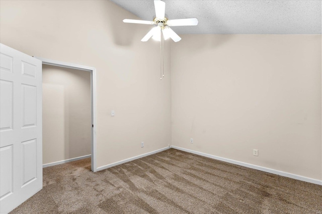 unfurnished bedroom featuring a textured ceiling, ceiling fan, lofted ceiling, carpet flooring, and baseboards