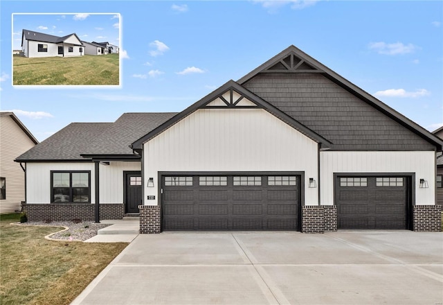 view of front of home with brick siding, concrete driveway, a garage, and a shingled roof