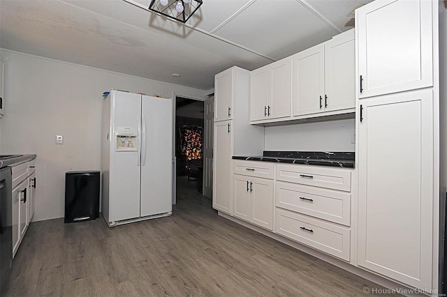 kitchen featuring dark countertops, white refrigerator with ice dispenser, white cabinetry, and wood finished floors