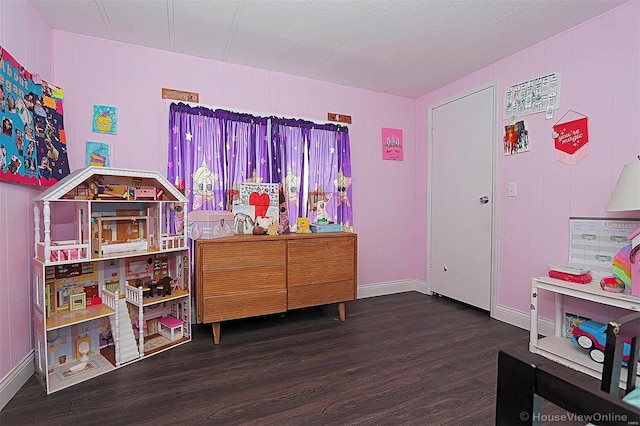 playroom featuring baseboards and wood finished floors