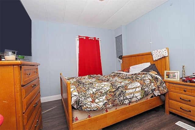 bedroom featuring visible vents and dark wood finished floors