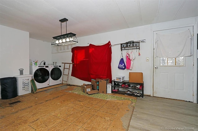 washroom featuring laundry area, wood finished floors, and washer and dryer