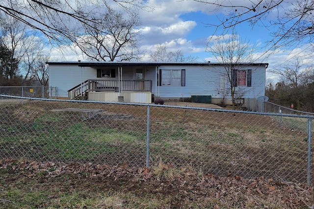 manufactured / mobile home with a fenced front yard and covered porch