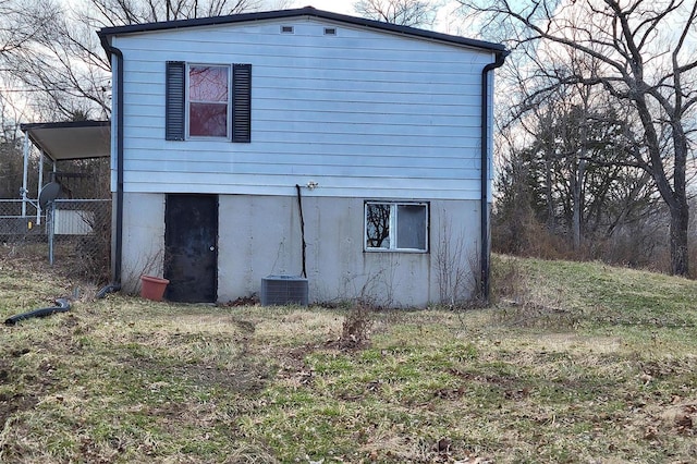 view of home's exterior with fence and central air condition unit