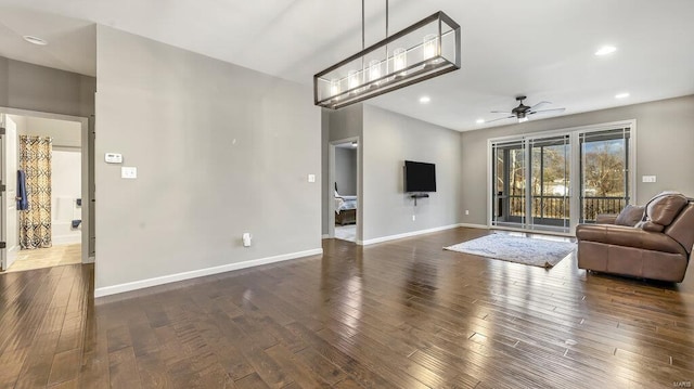 living area featuring dark wood finished floors, recessed lighting, ceiling fan, and baseboards