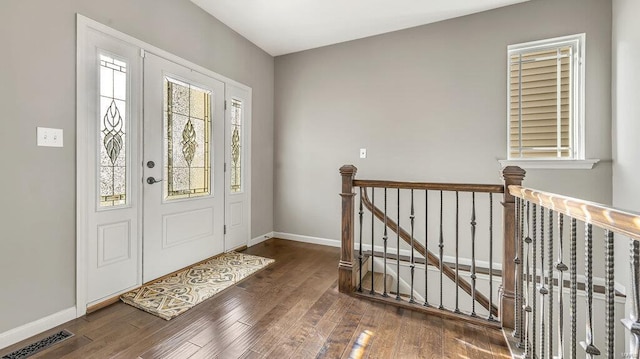 foyer featuring visible vents, wood finished floors, and baseboards