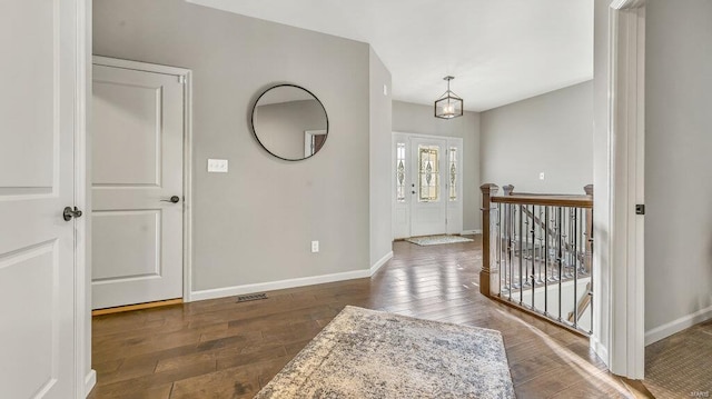 entrance foyer with visible vents, baseboards, and hardwood / wood-style floors