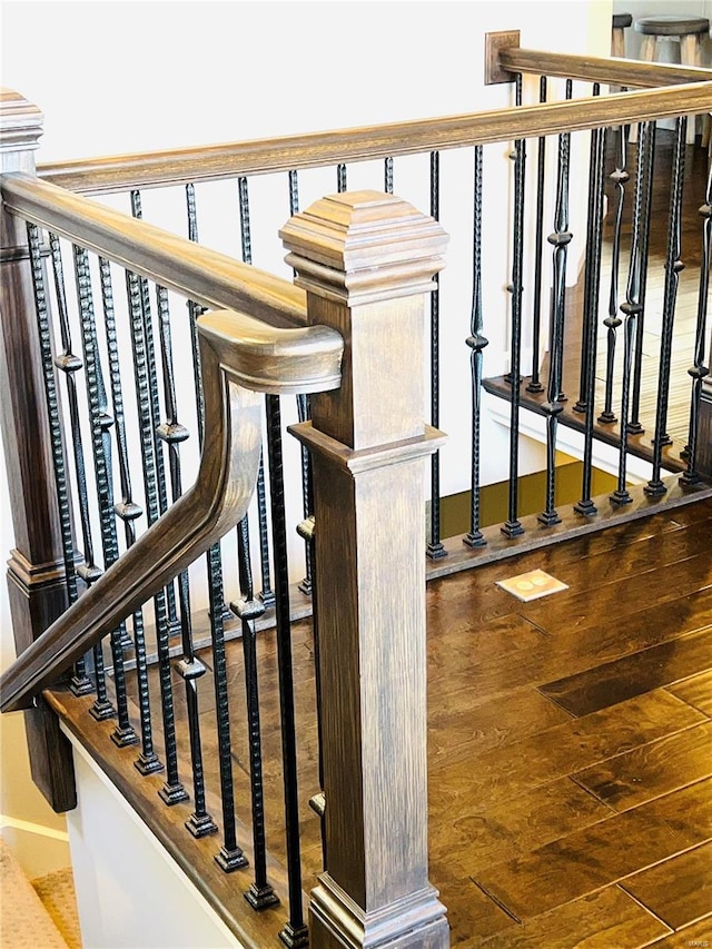 stairway featuring wood finished floors