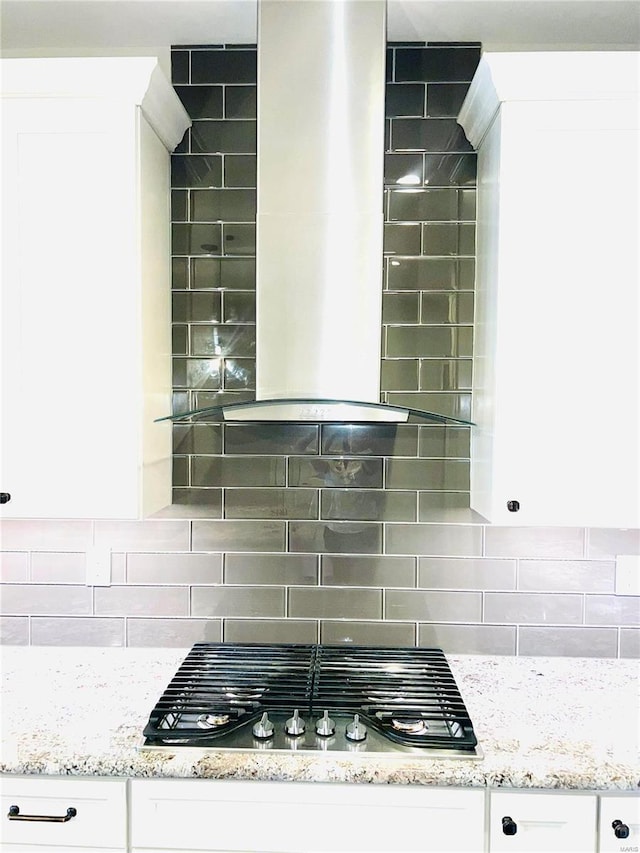 kitchen featuring tasteful backsplash, white cabinetry, and stainless steel gas stovetop