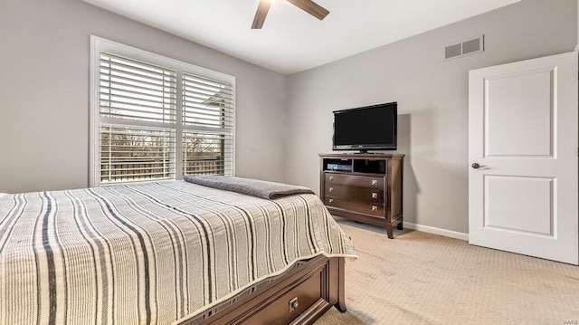 bedroom featuring visible vents, light colored carpet, baseboards, and ceiling fan