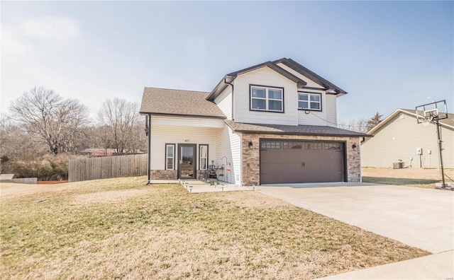 view of front of property with a garage, driveway, stone siding, fence, and a front lawn