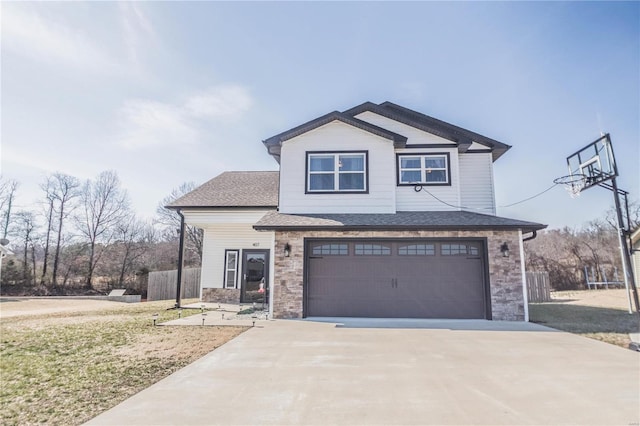 view of front facade featuring a garage, stone siding, fence, and concrete driveway