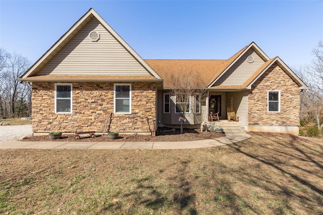 single story home featuring a front lawn, stone siding, and a shingled roof