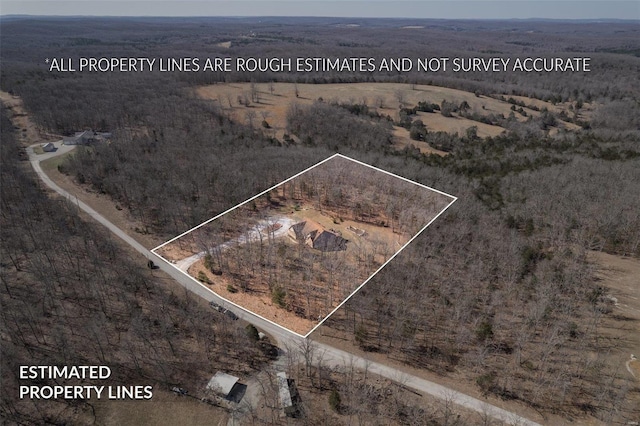 birds eye view of property with a rural view