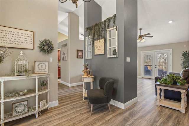 hallway featuring french doors, baseboards, visible vents, and wood finished floors