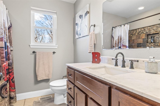 bathroom with vanity, visible vents, baseboards, tile patterned flooring, and toilet