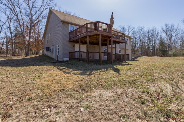 back of property featuring a deck and a yard