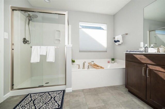 full bathroom with vanity, a shower stall, a garden tub, and tile patterned floors