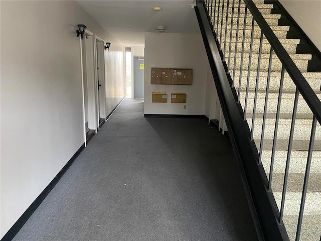 hallway with stairs and baseboards