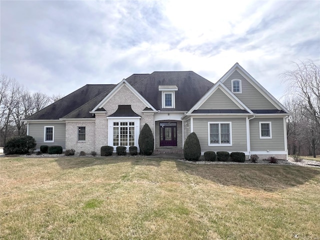 view of front facade with a front yard and brick siding