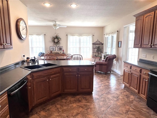 kitchen with a textured ceiling, dishwashing machine, a peninsula, a sink, and dark countertops