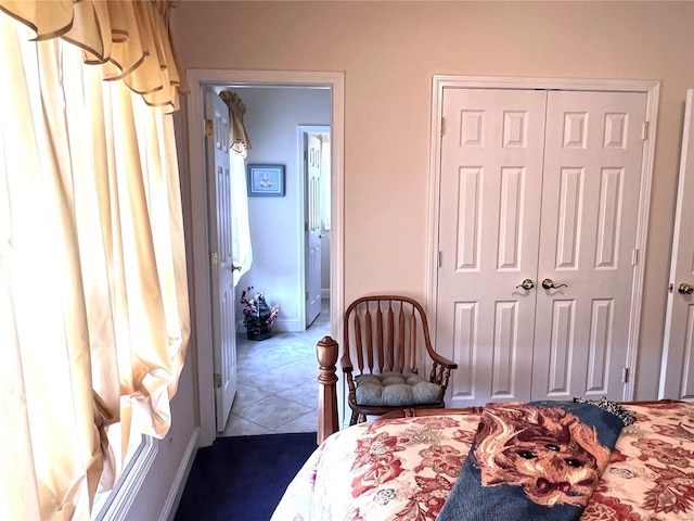 tiled bedroom featuring a closet