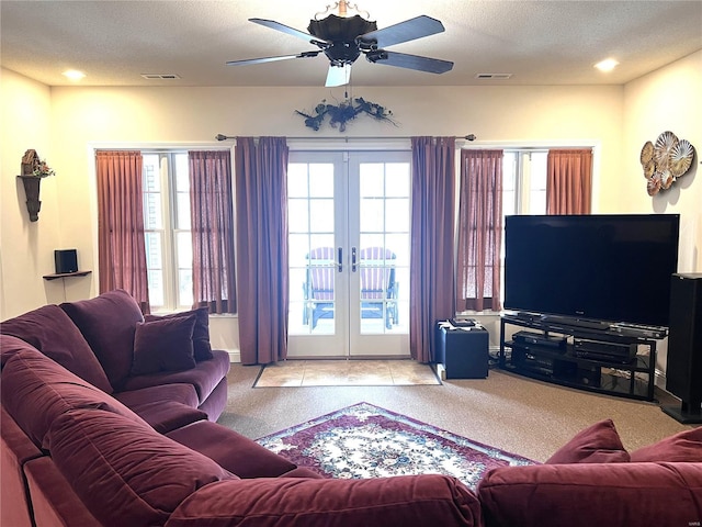 living area with carpet, french doors, and visible vents