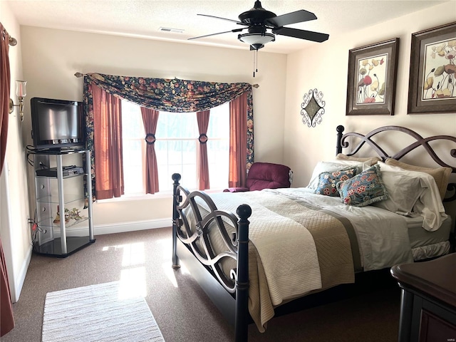 bedroom featuring carpet floors, a ceiling fan, visible vents, and baseboards