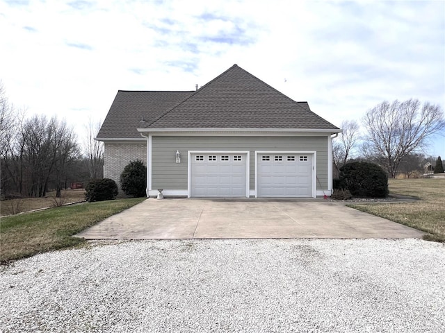 view of side of property featuring a garage, driveway, and a shingled roof