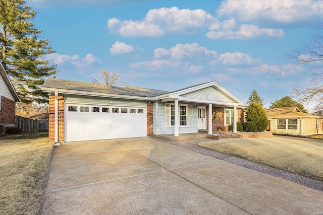 ranch-style home with driveway, fence, covered porch, an attached garage, and brick siding