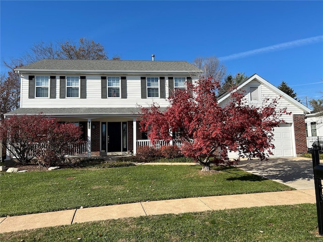 view of front facade with driveway, a porch, an attached garage, a front lawn, and brick siding