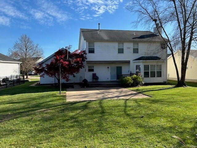 rear view of house featuring a patio area and a lawn