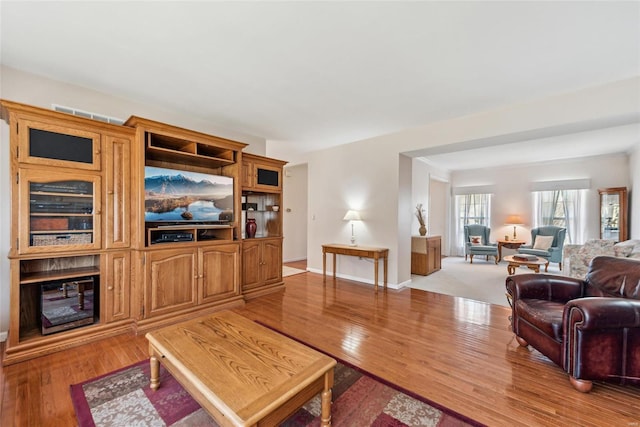 living area featuring light wood-style flooring and baseboards