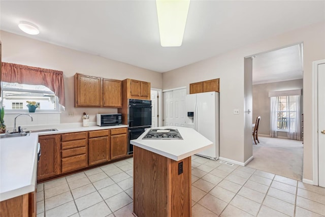 kitchen featuring brown cabinetry, light tile patterned floors, white refrigerator with ice dispenser, and dobule oven black