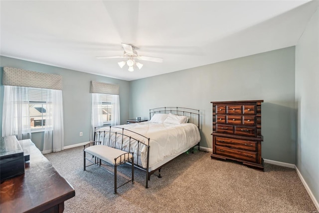 carpeted bedroom featuring a ceiling fan and baseboards