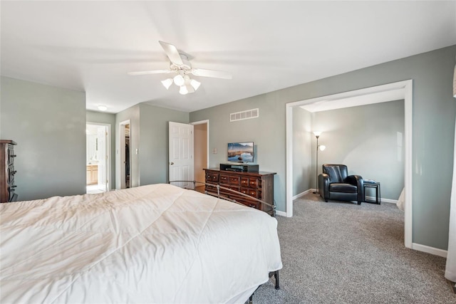 carpeted bedroom with a ceiling fan, ensuite bath, baseboards, and visible vents