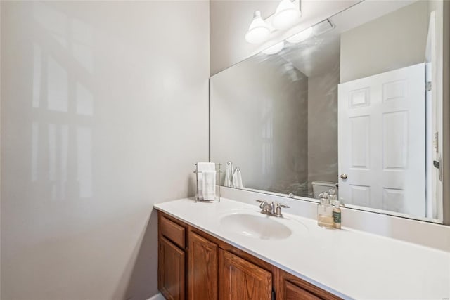 bathroom featuring toilet and vanity