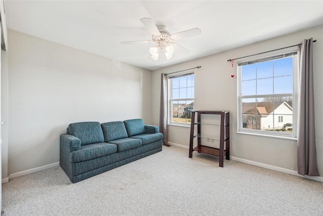 sitting room with carpet, a ceiling fan, and baseboards