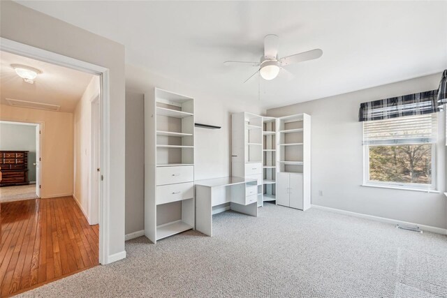 unfurnished bedroom with attic access, baseboards, and carpet floors