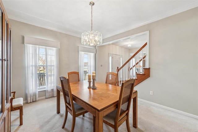 dining area featuring crown molding, light colored carpet, and baseboards