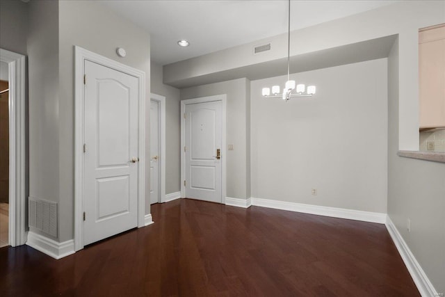 unfurnished dining area featuring visible vents, baseboards, and wood finished floors