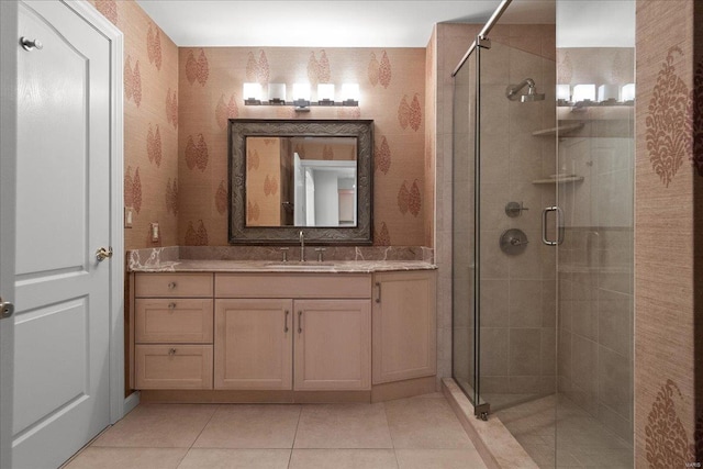 full bath with a shower stall, vanity, and wallpapered walls