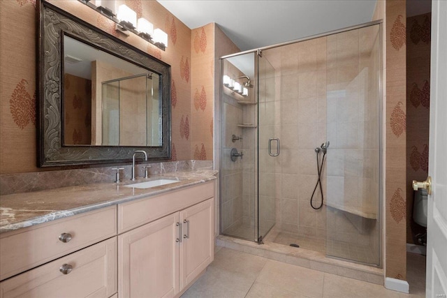 full bathroom featuring a shower stall, vanity, and tile patterned floors