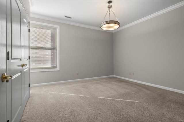 empty room featuring baseboards, carpet, visible vents, and crown molding